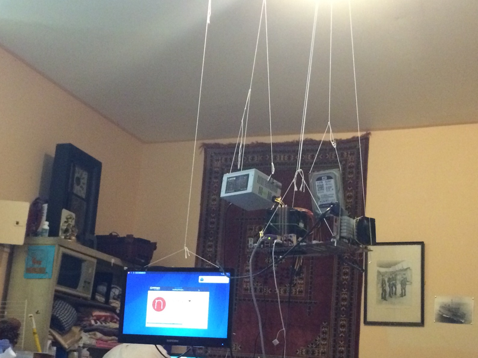 This computer is suspended by string to the ceiling. Eureka!