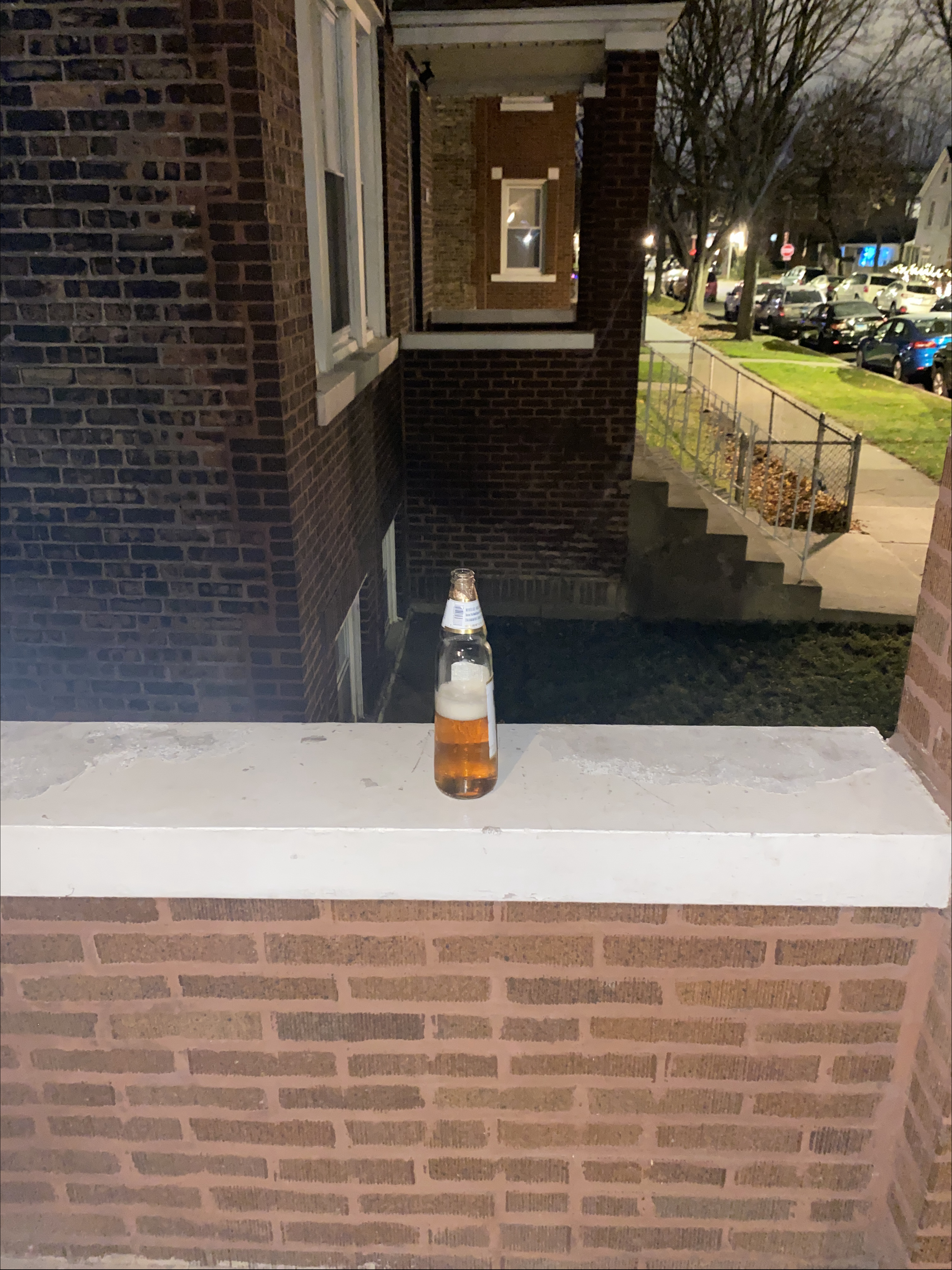 a tall modelo on the stoop
