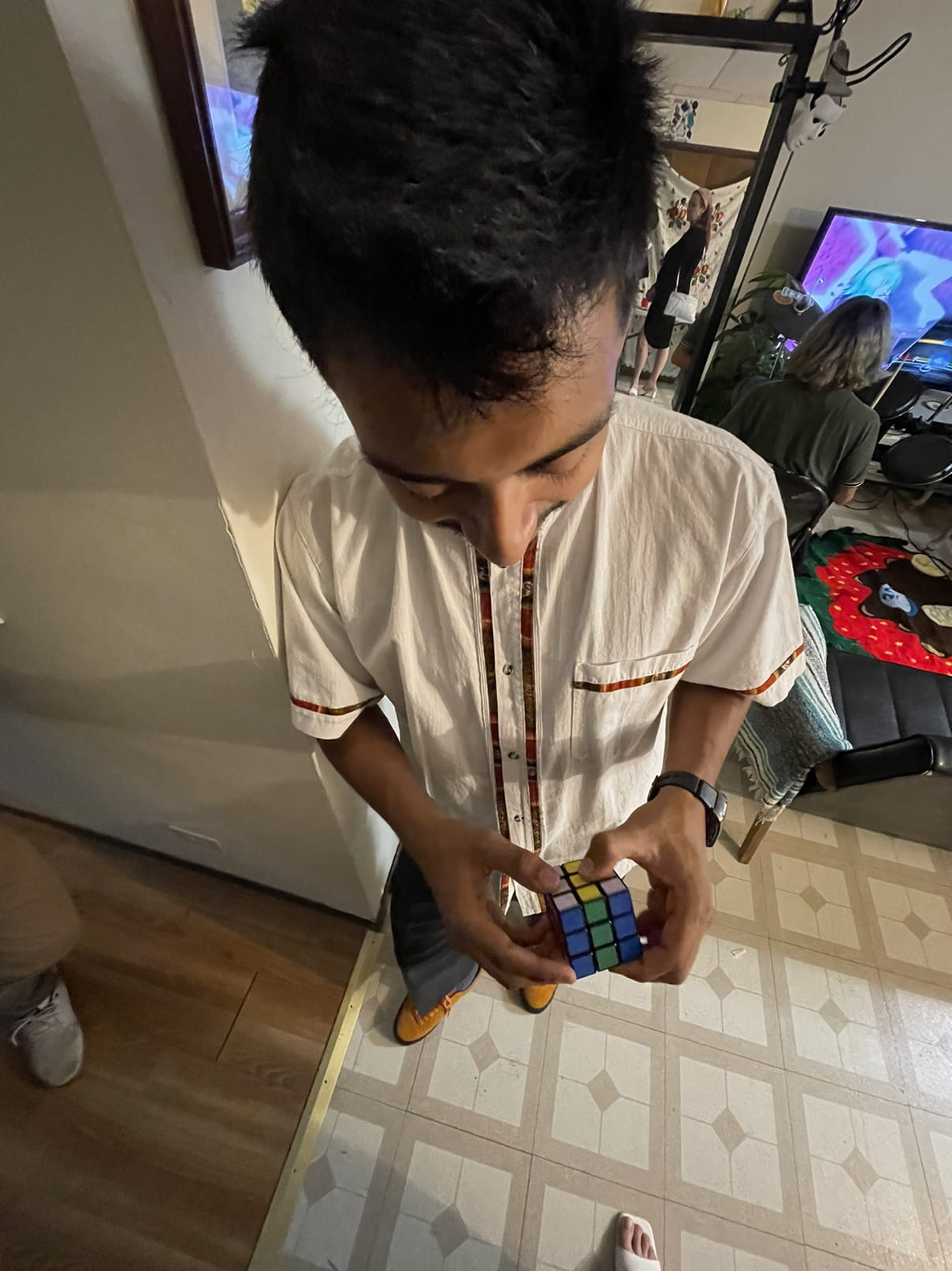Alex solving a rubix cube at his housewarming party