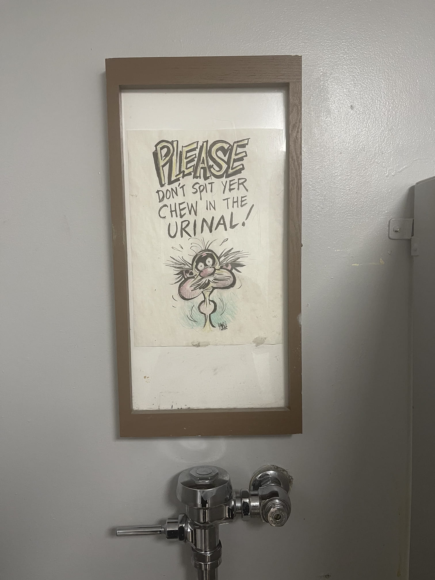 Sign above the urinal steer in