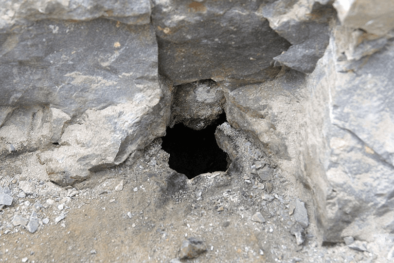 A hole in a cave. Possibly an entrance