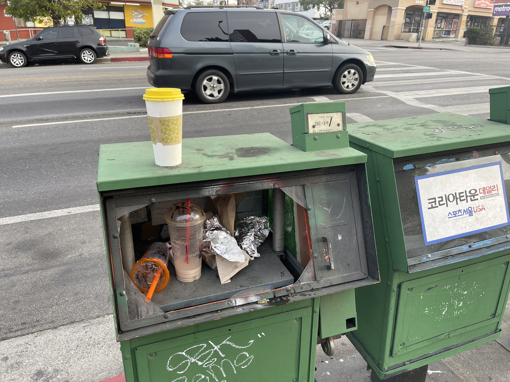 Bunch of shit inside and on top of newspaper box 